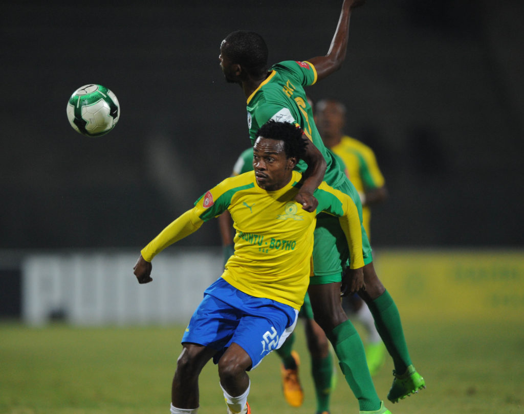 Percy Tau of Mamelodi Sundowns is challenged by Olaleng Shaku of Baroka