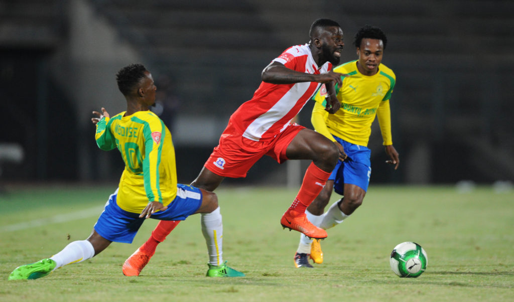 Fortune Makaringe challenged by Teko Modise and Percy Tau