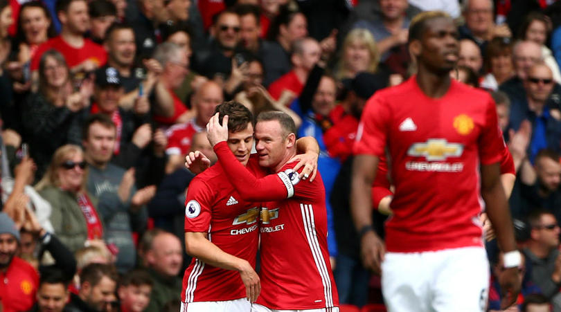 Josh Harrop celebrates his debut goal with Wayne Rooney