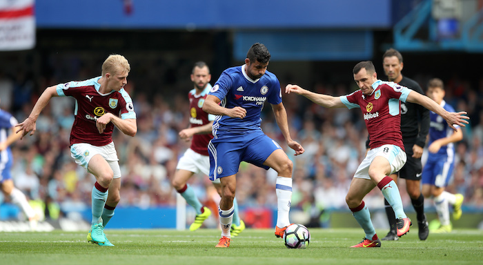 Diego Costa and Dean Marney battle for the ball