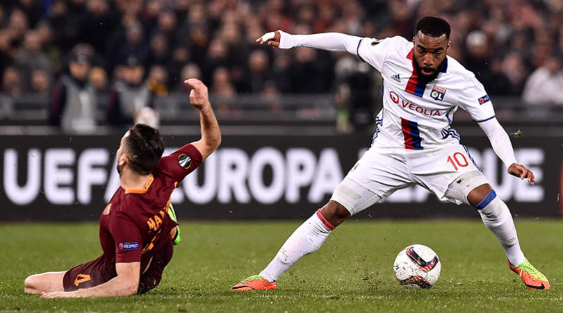 Alexandre Lacazette is challenged by Konstantinos Manolas