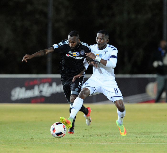 Mpho Makola is challenged by Thabang Monare