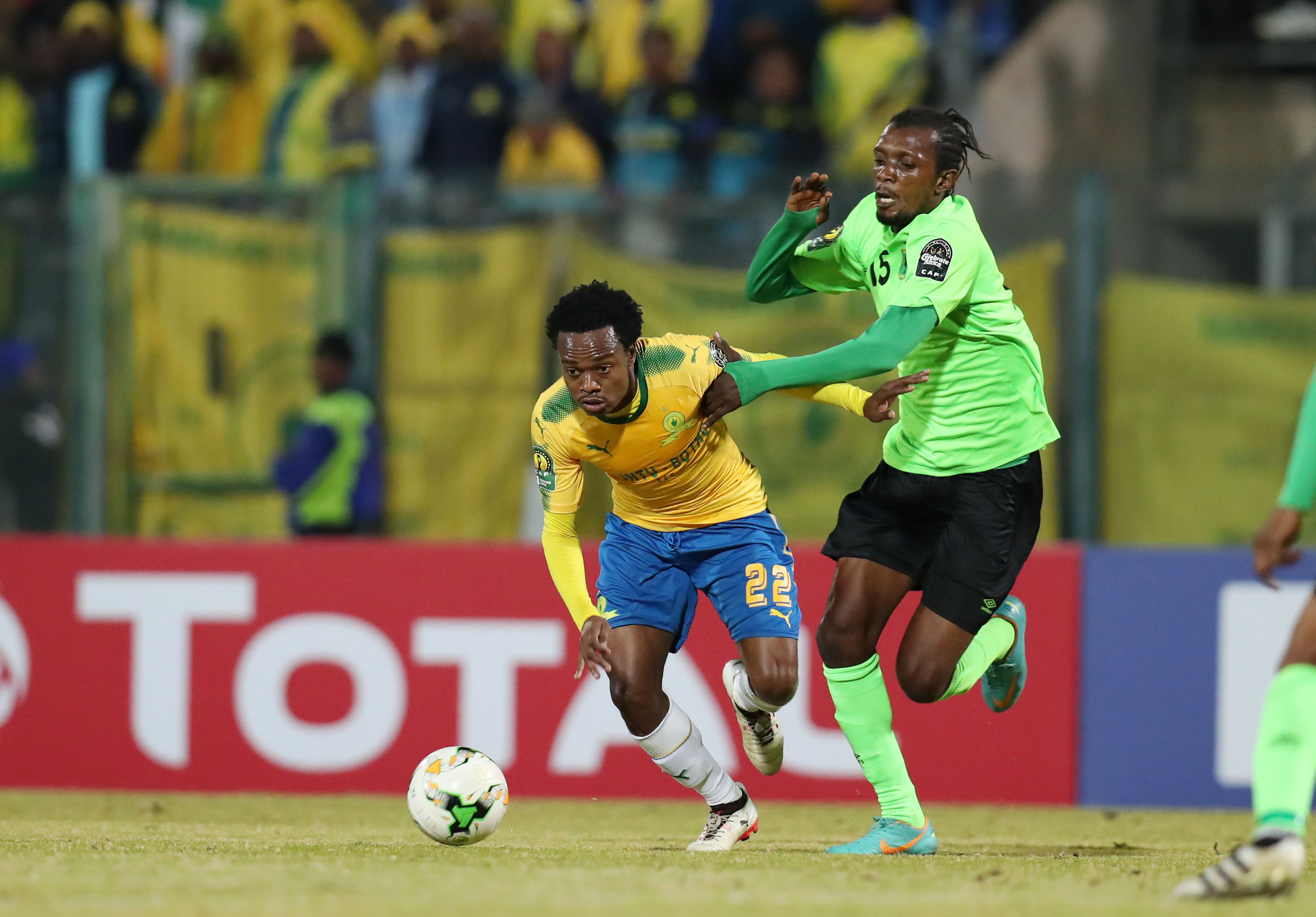 Percy Tau challenged by Bopunga Botuli 