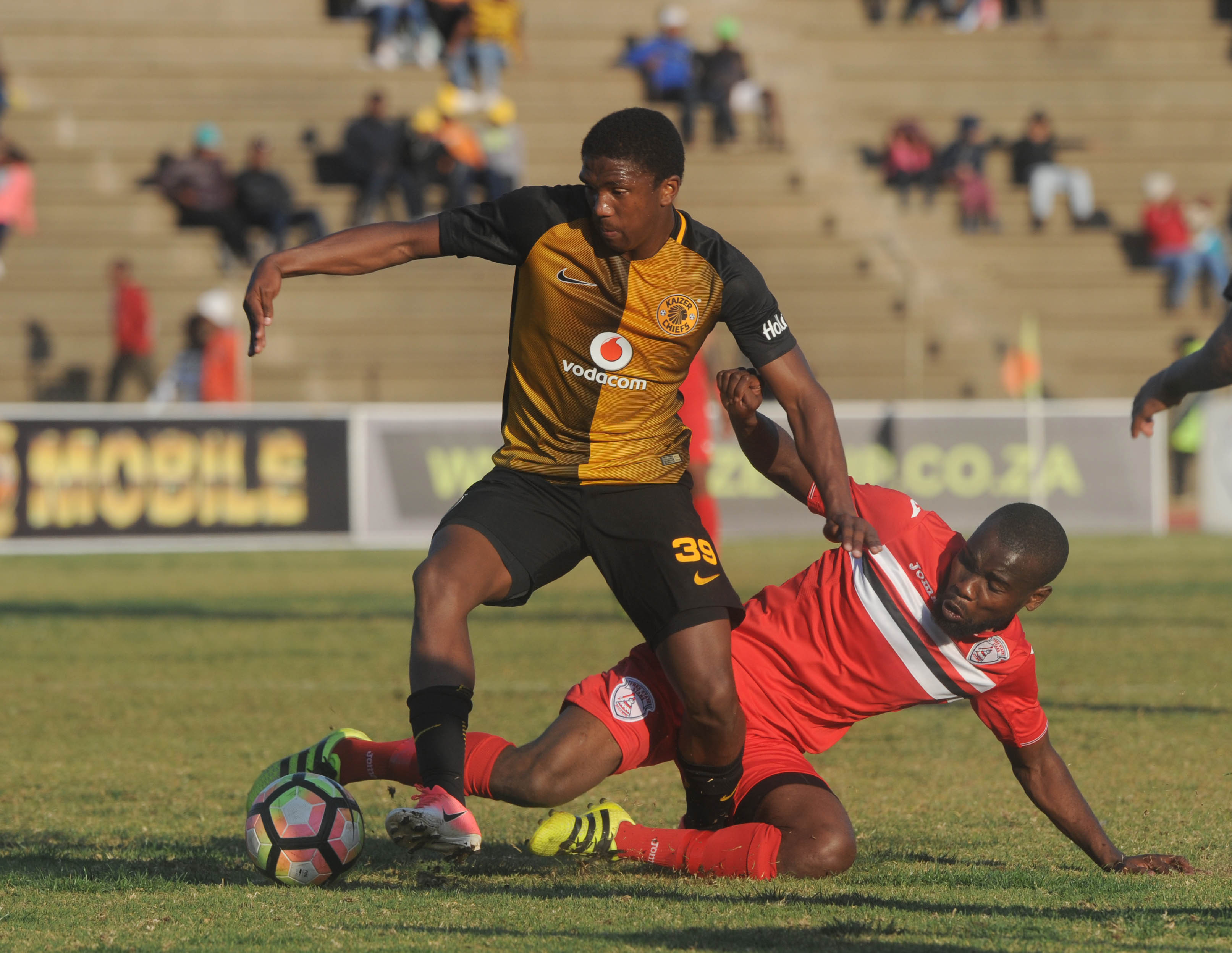 Itumeleng Shopane is tackled by Makhehleni Makhaula