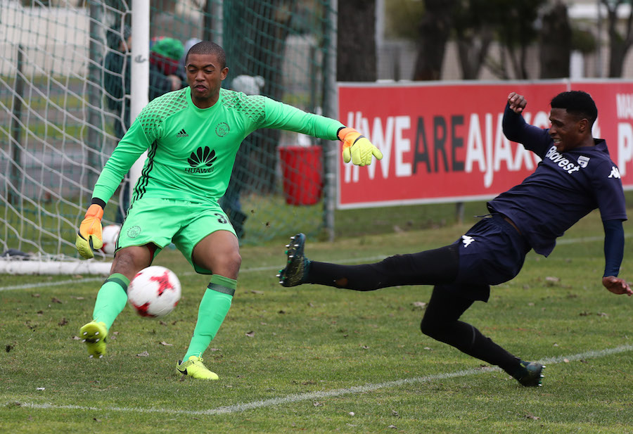 Jody February clears ball from Vincent Pule