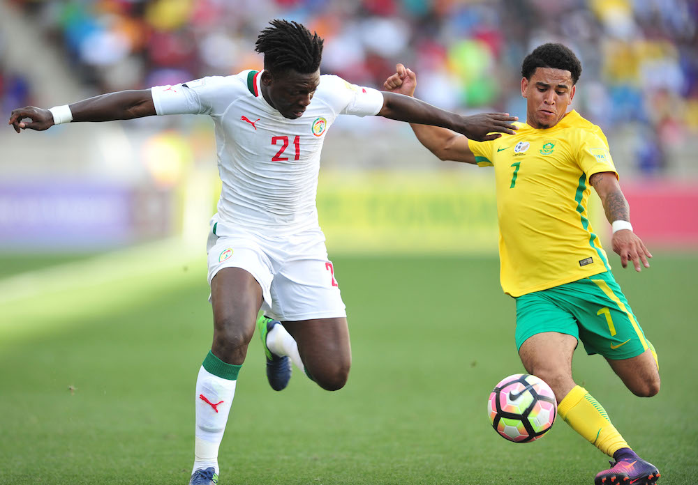 Keagan Dolly challenged by Lamine Gassama