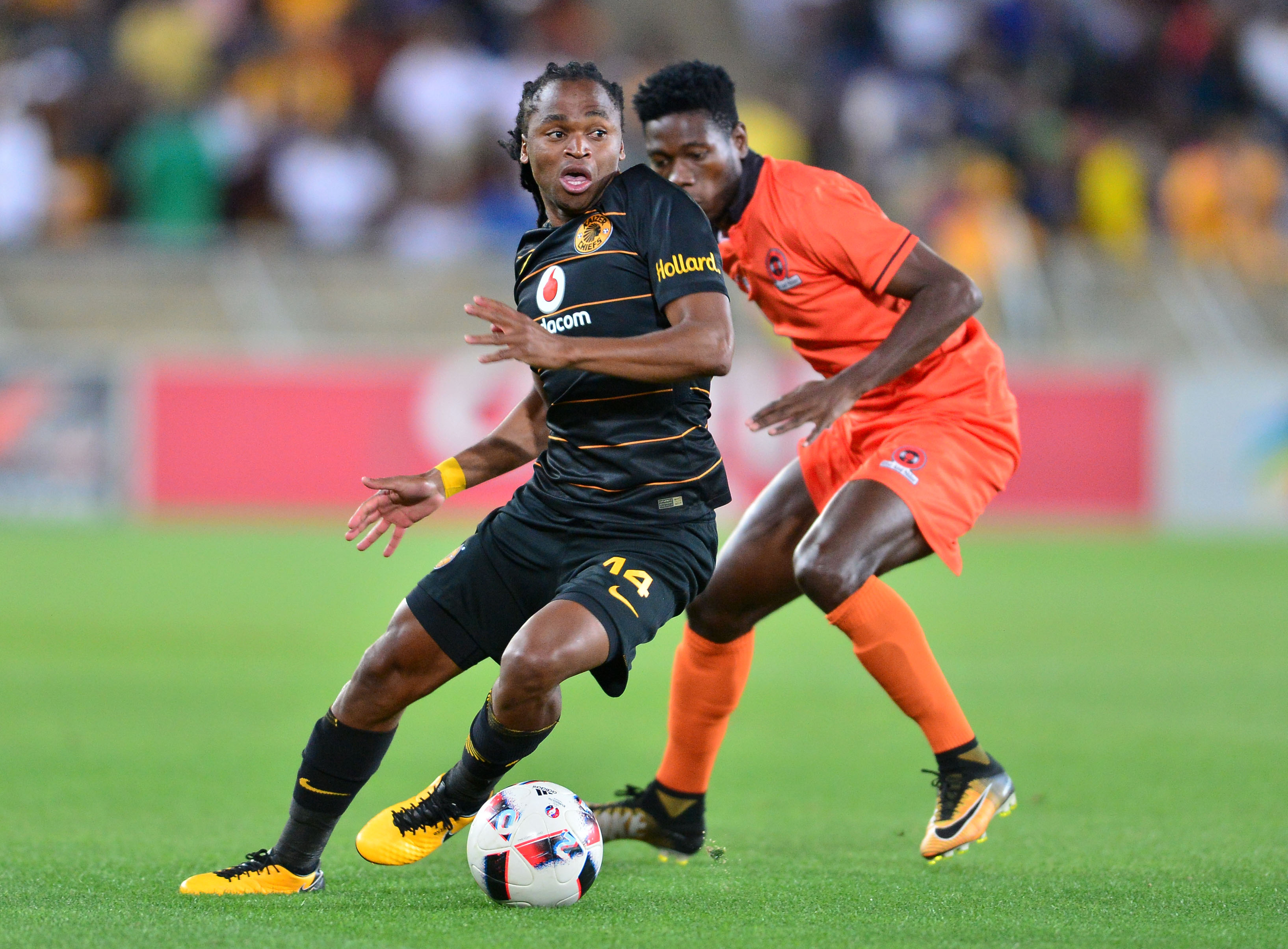 Siphiwe Tshabalala challenged by Salulani Phiri