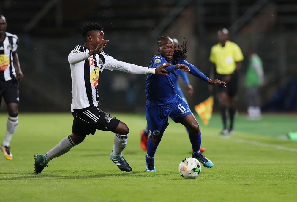 Reneilwe Letsholonyane and Nathan Sinkala challenge for the ball