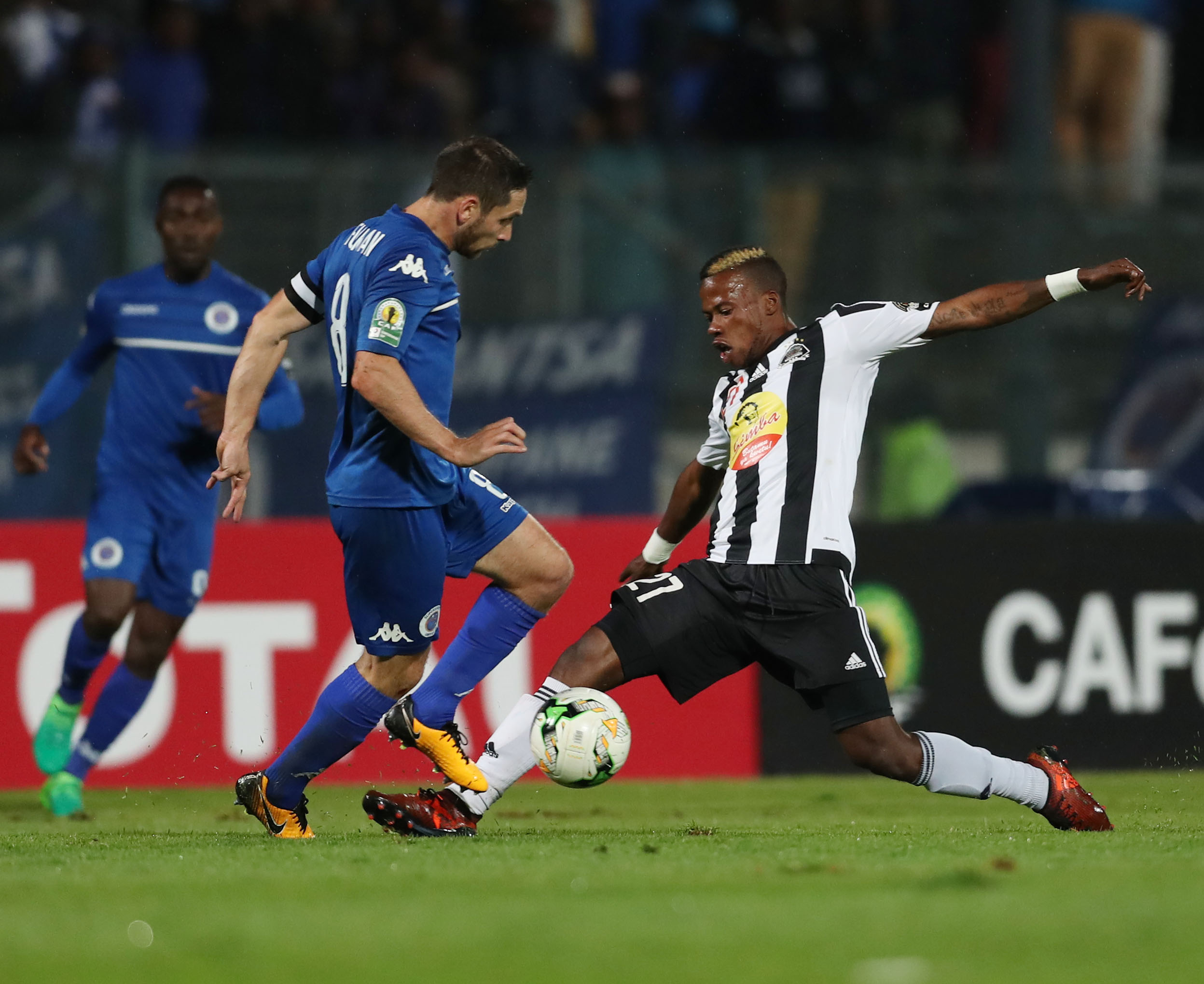 Michee Mika tackles Dean Furman for the ball