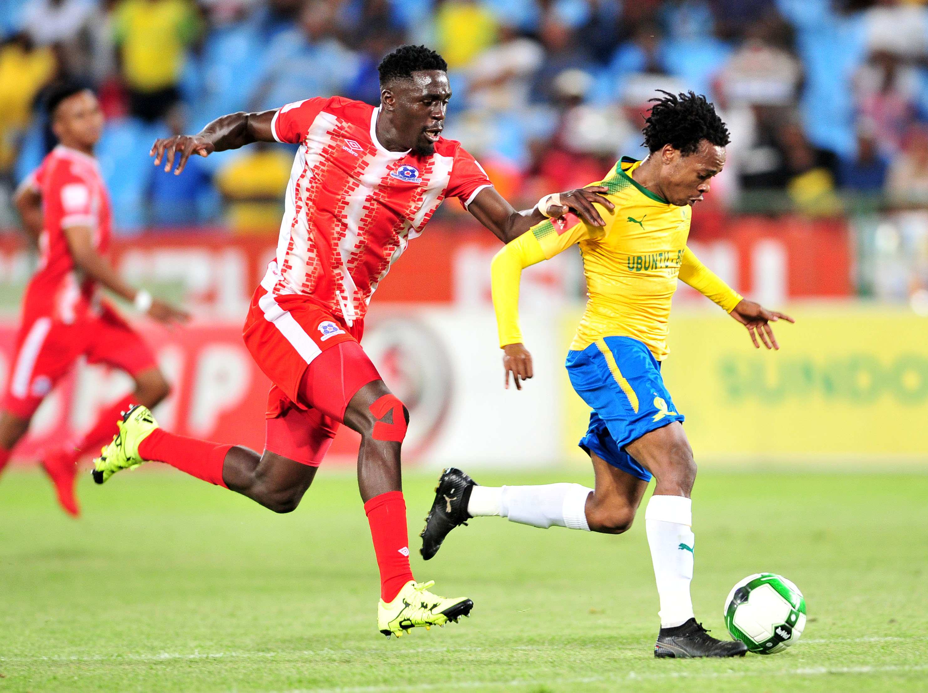 Percy Tau challenged by Brian Onyango