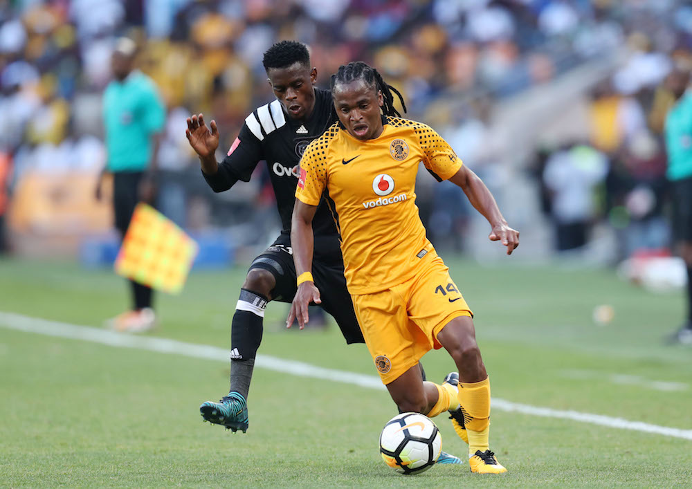 Siphiwe Tshabalala challenged by Innocent Maela