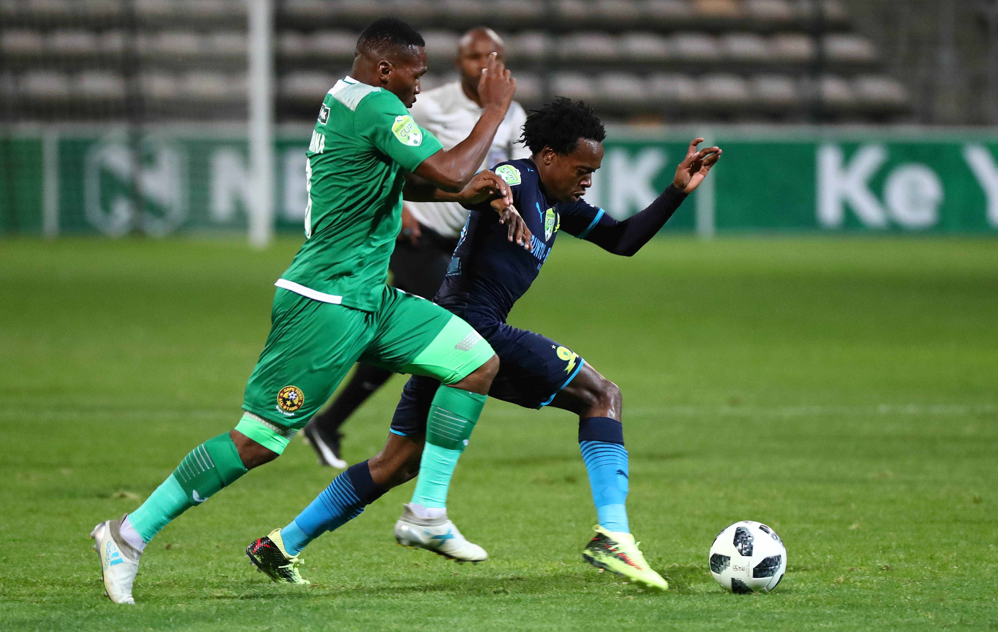 Percy Tau evades a challenge from Mlungisi Mbunjana