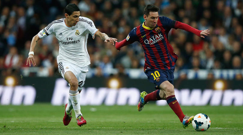 Lionel Messi goes past Angel Di Maria