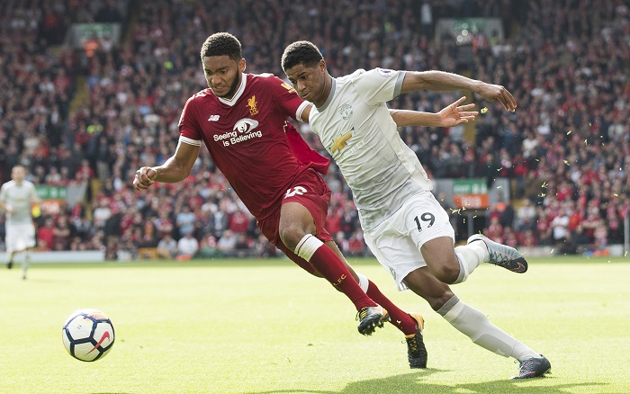 Marcus Rashford in action with Joseph Gomez