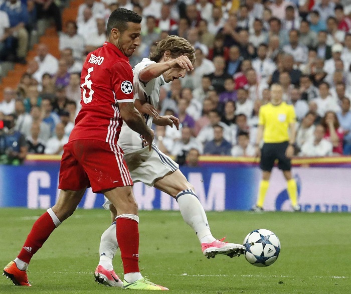 Bayern Munich's Thiago Alcantara fights for the ball with Luka Modric of Real Madrid.