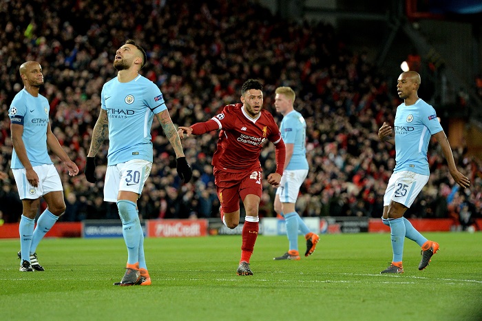 Players of ManCity react as Liverpool's Alex Oxlade-Chamberlain celebrates after scoring.