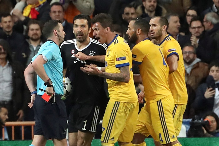 Referee Michael Oliver shows Juventus' goalkeeper Gianluigi Buffon the red card.