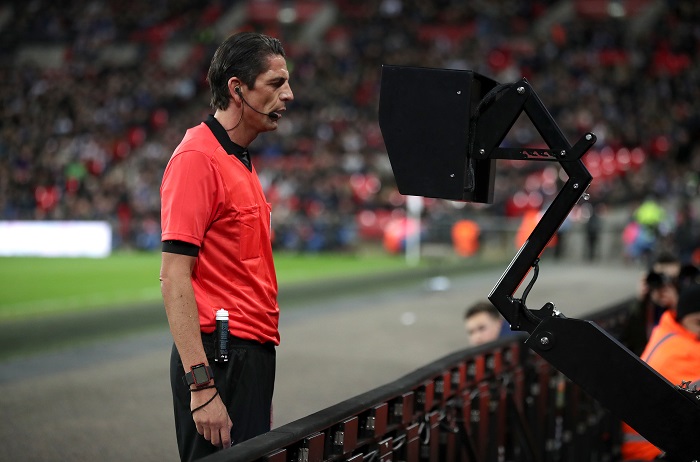 Match referee Deniz Aytekin consults the VAR system in an International friendly between England and Italy.