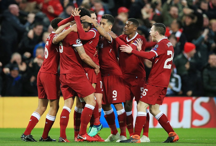 Liverpool players celebrate scoring the opening goal against Roma.