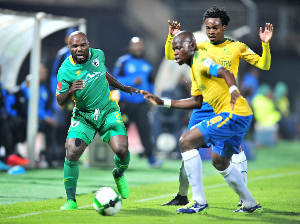 Matome Kgoetyane challenged by Percy Tau and Hlompho Kekana