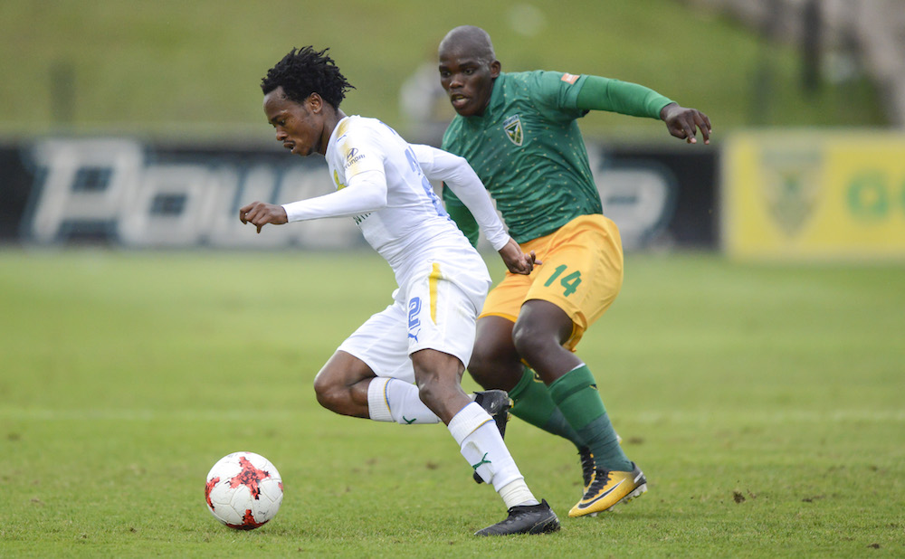 Siyabonga Dube keeps an close eye on Percy Tau