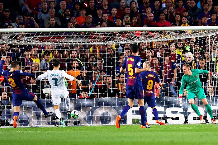 Real Madrid's forward Cristiano Ronaldo scores against Barcelona.