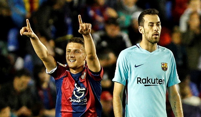 Barcelona midfielder Sergio Busquets looks on as Levante's Macedonian midfielder Enis Bardhi celebrates scoring.