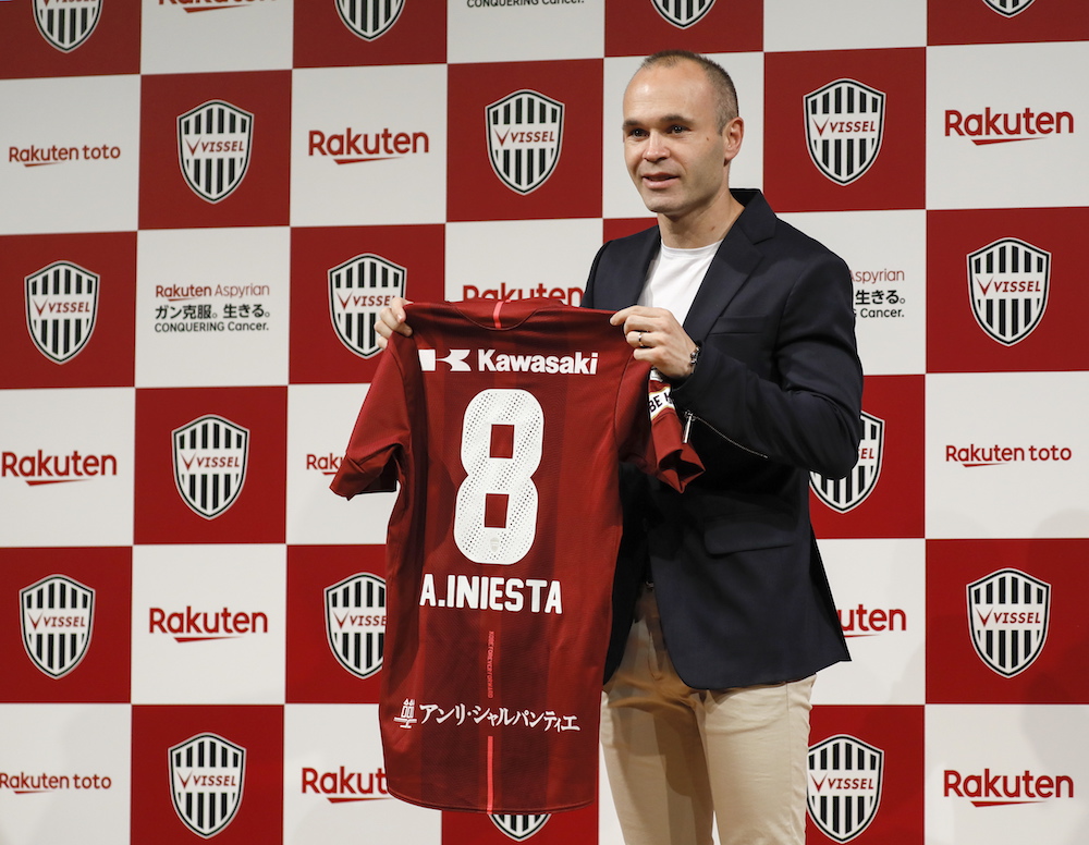 Spanish soccer player Andres Iniesta shows off his new jersey