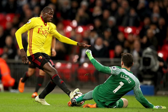 Watford's Abdoulaye Doucoure and Tottenham Hotspur goalkeeper Hugo Lloris battle for the ball