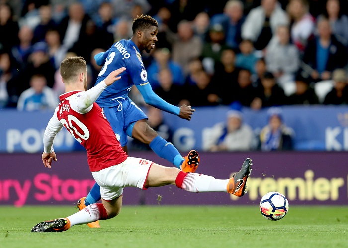 Arsenal's Shkodran Mustafi slides in as Leicester City's Kelechi Iheanacho has a shot.