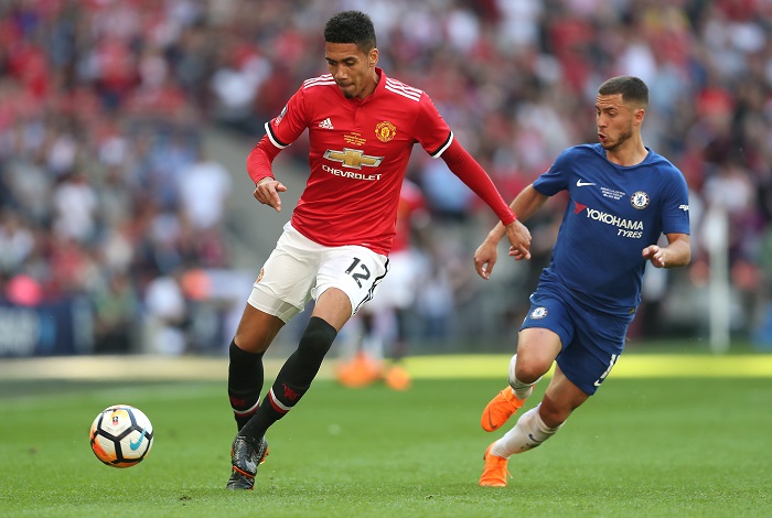 Manchester United's Chris Smalling and Chelsea winger Eden Hazard battle for the ball.