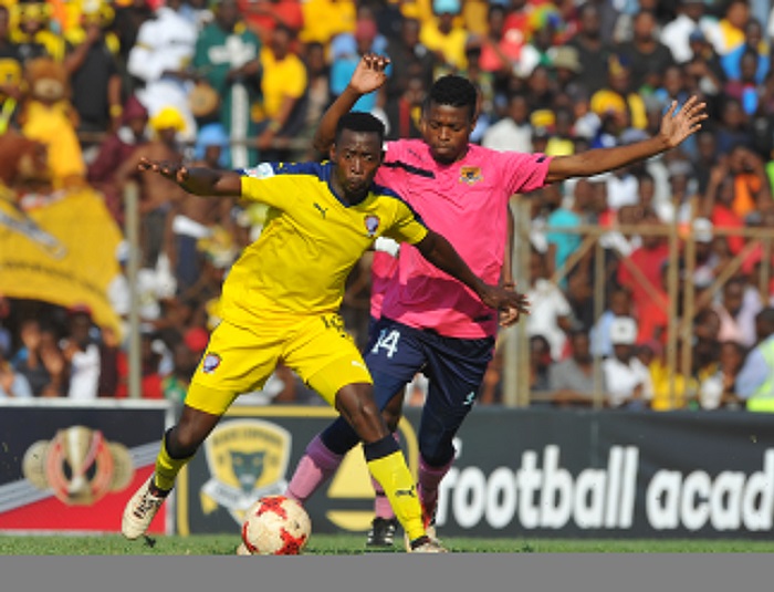 Tebogo Mabula of Jomo Cosmos is challenged by Phathutshedzo Nange of Black Leopards.