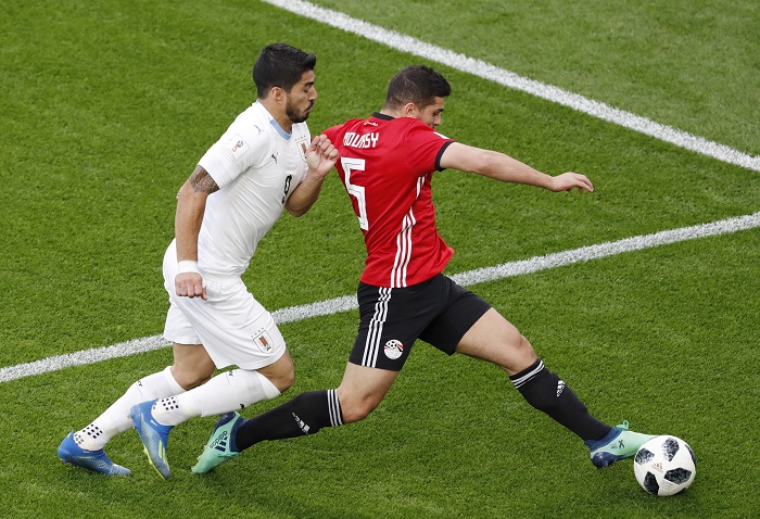 Luis Suarez of Uruguay in action against Sam Morsy of Egypt.