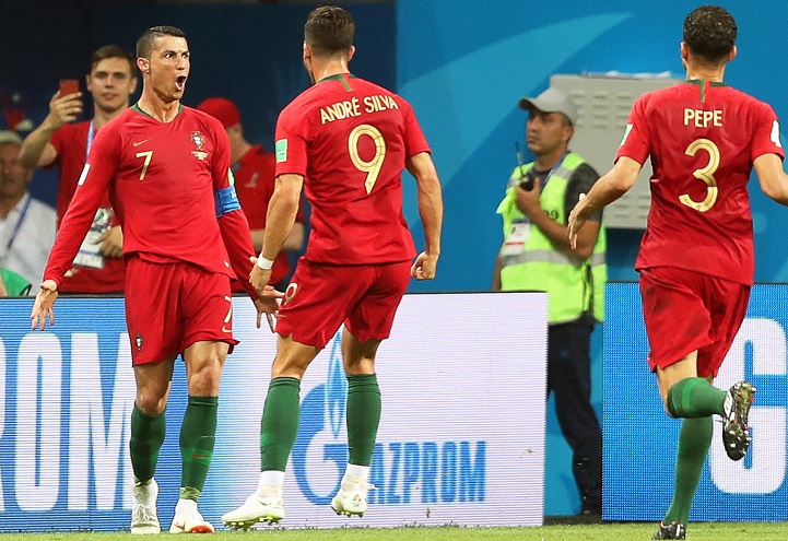 Cristiano Ronaldo of Portugal celebrates with his teammates after scoring the 3-3 equalizer against Spain.