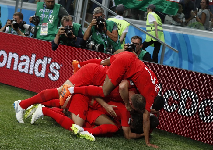 Players of England celebrate after scoring the winning goal against Tunisia.