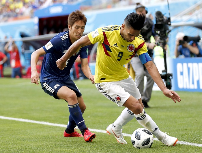 Radamel Falcao of Colombia and Genki Haraguchi of Japan.