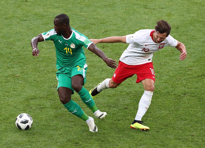 Grzegorz Krychowiak of Poland and Moussa Konate of Senegal.