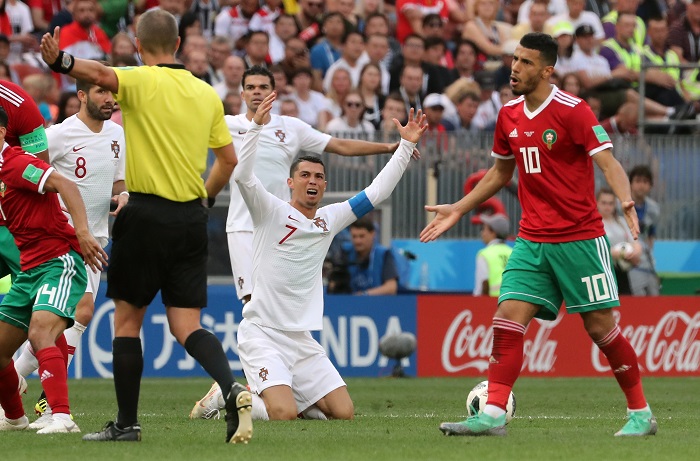 Cristiano Ronaldo of Portugal (C) reacts after being fouled against Morocco.