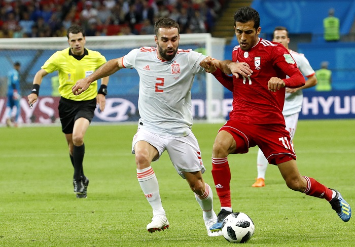 Dani Carvajal of Spain and Vahid Amiri of Iran.