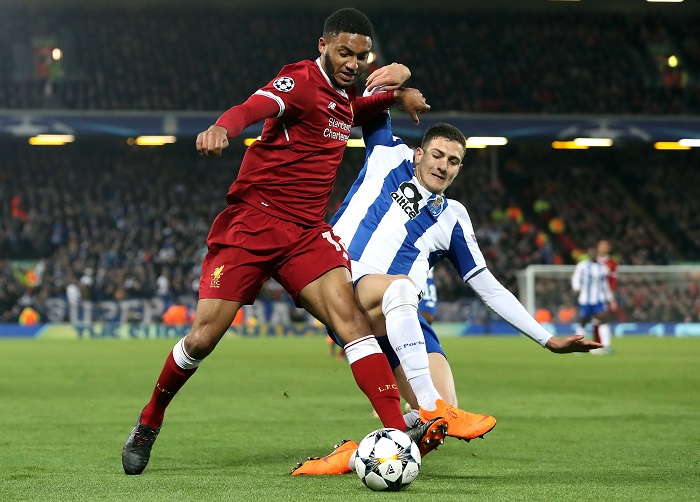 Liverpool's Joe Gomez and Diogo Dalot battle for the ball.