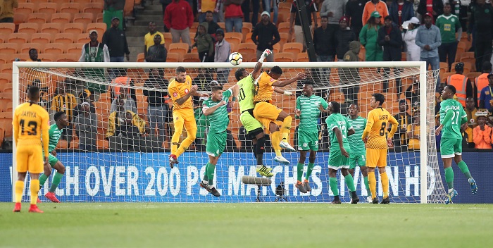 Patrick Tignyemb of Bloemfontein Celtic clears ball from Siyabonga Ngezana of Kaizer Chiefs.