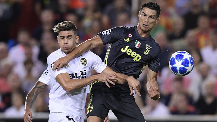 Valencia's Gabriel Paulista vies with Juventus' forward Cristiano Ronaldo.