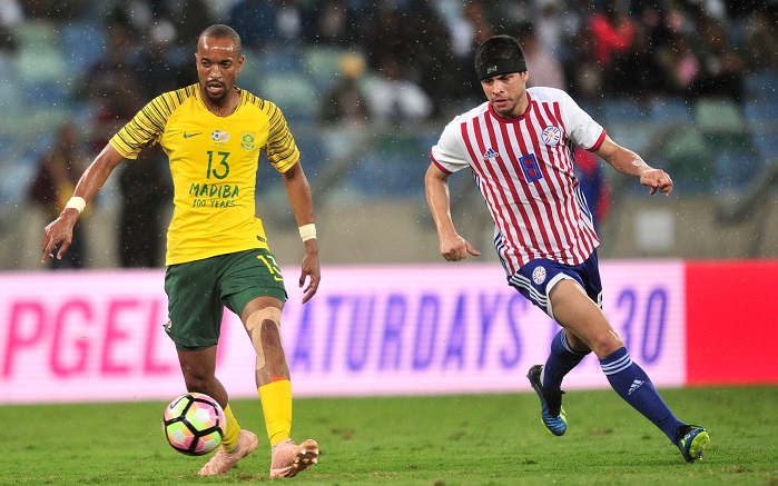 Tiyani Mabunda of Bafana Bafana in action with Rodrigo Rojas of Paraguay