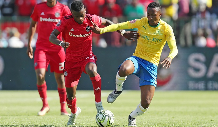 Lebohang Maboe of Mamelodi Sundowns challenges Innocent Maela of Orlando Pirates