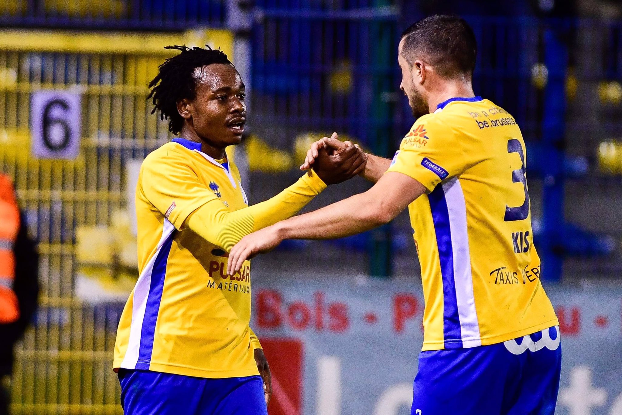 Percy Tau celebrates his brace with teammate