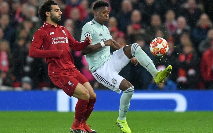 Mohamed Salah of Liverpool challenges David Alaba of Bayern Munich