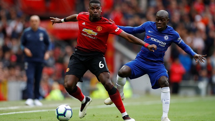 Paul Pogba of Manchester United shields the ball from his France international team-mate N'Golo Kante