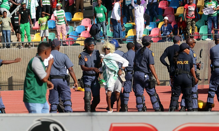 Police escorting Bloemfontein Celtic supporters off the field