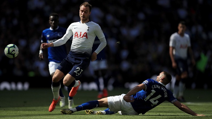 Spurs' Christian Eriksen evades a challenge from Cenk Tosun of Everton