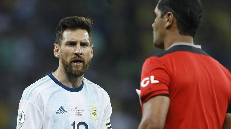 Argentina's Lionel Messi, left, complains to the referee